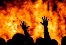 Set Ablaze After Threats – Shocking Miami Turn silhouetted hands raised before a large fire