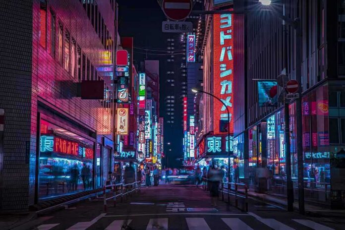 Night city street with neon signs and blurred pedestrians