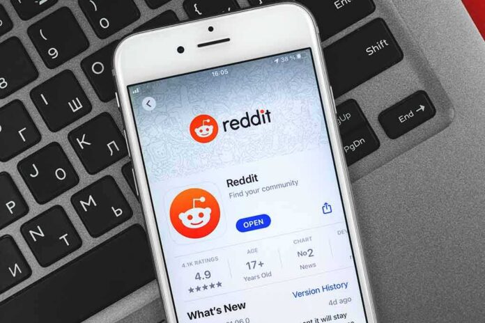 iPhone showing Reddit app page on a laptop keyboard