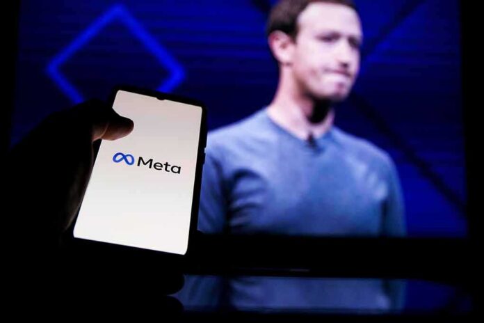 shutterstock_2146826979 Mark Zuckerberg on screen with a hand holding a phone showing the Meta logo