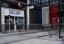 Generals Warned: Paris Near Boiling Point Police station entrance with barriers and French flag colors