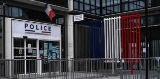 Police station entrance with barriers and French flag colors