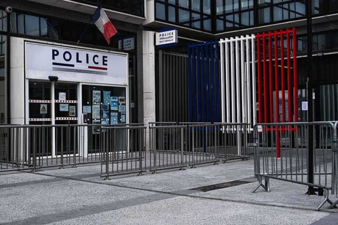 Police station entrance with barriers and French flag colors