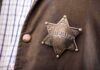 Sheriff badge on a brown jacket