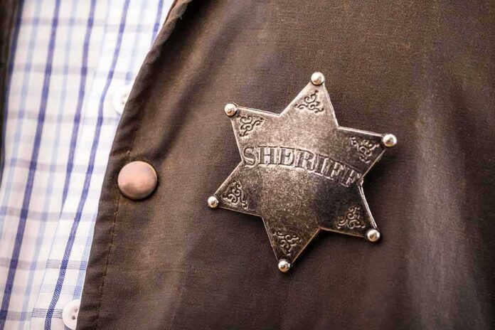 shutterstock_779687242-1 Sheriff badge on a brown jacket