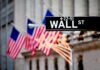 Wall Street sign with American flags in the background